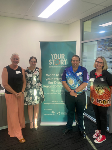 four people standing by the Your Story banner