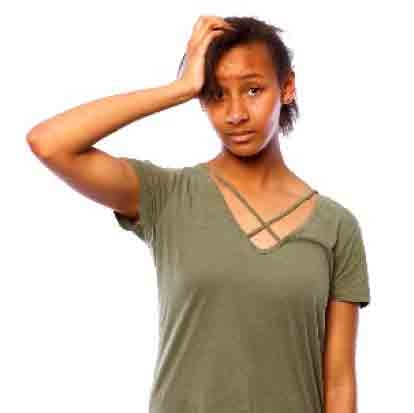 Woman with her hand to her head in worry