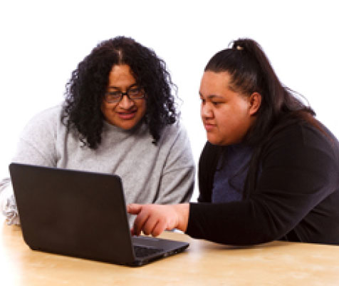 people sitting at a laptop