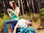 person in wheelchair slumped over while carer is busy on her mobile phone