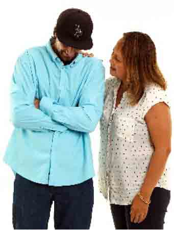 Woman with her hand on a man's shoulder, showing support