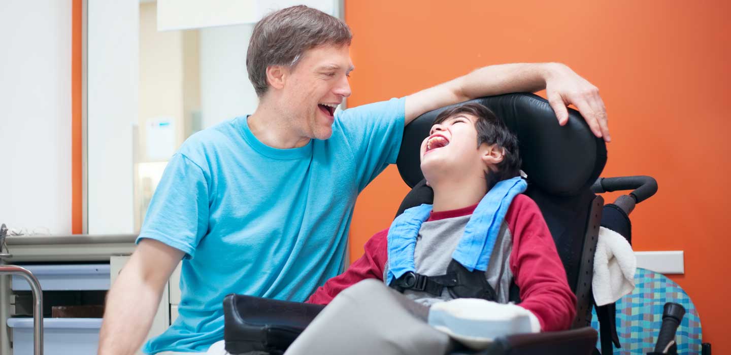 Michael laughing with his nephew who has a disability